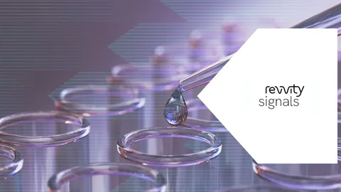 Several pink test tubes in a rack while a pipette drops liquid into one test tube