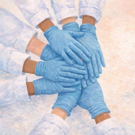 Overlapping female hands wearing blue nitrile gloves, with childrens toys positioned in the background.  