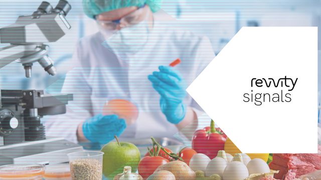 Scientist testing food samples in a lab with fresh produce, illustrating food safety analysis. 