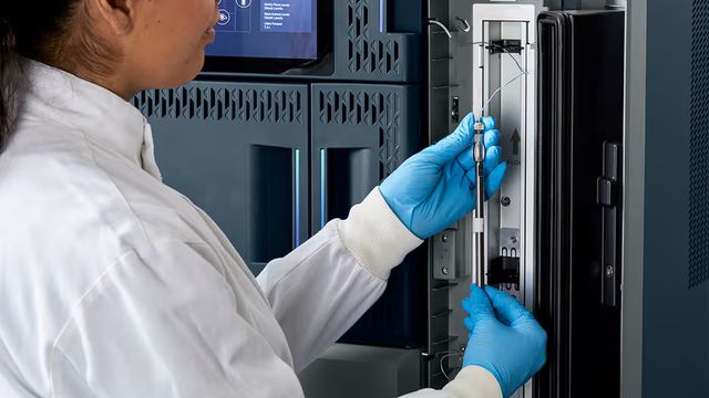Scientist adjusting chromatography equipment to optimize UHPLC to HPLC method scaling. 