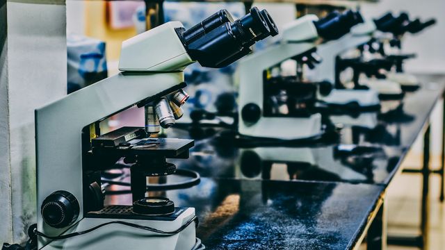 Microscope on a laboratory bench used for scientific research and analysis. 