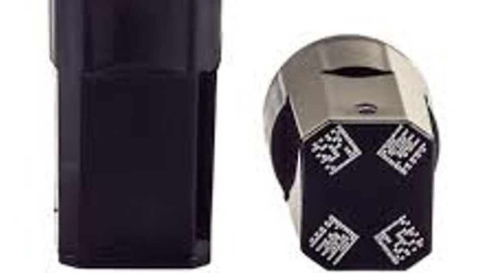 Black acoustic sample tube with cap featuring multiple 2D barcodes for lab tracking.
