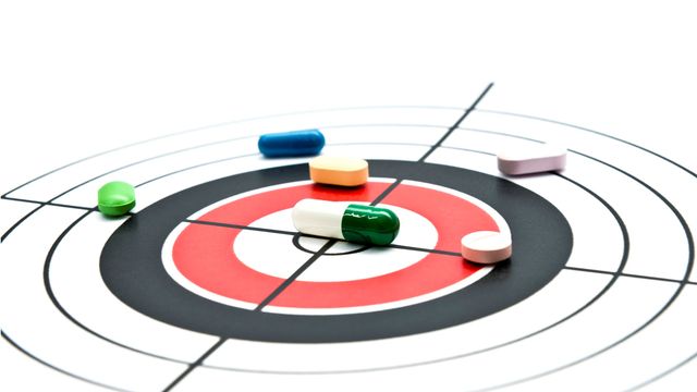 Various oral medications lie on a target. 