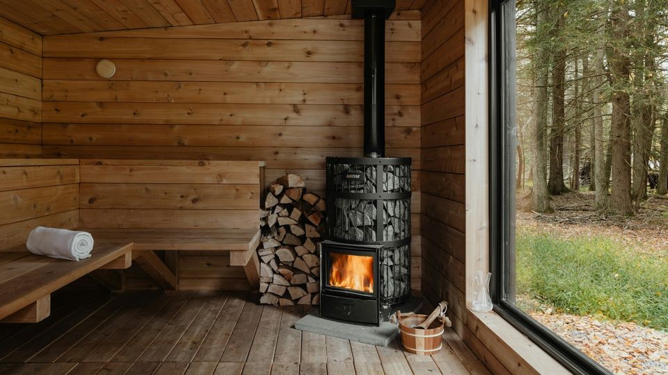 Modern wooden stove inside a sauna.