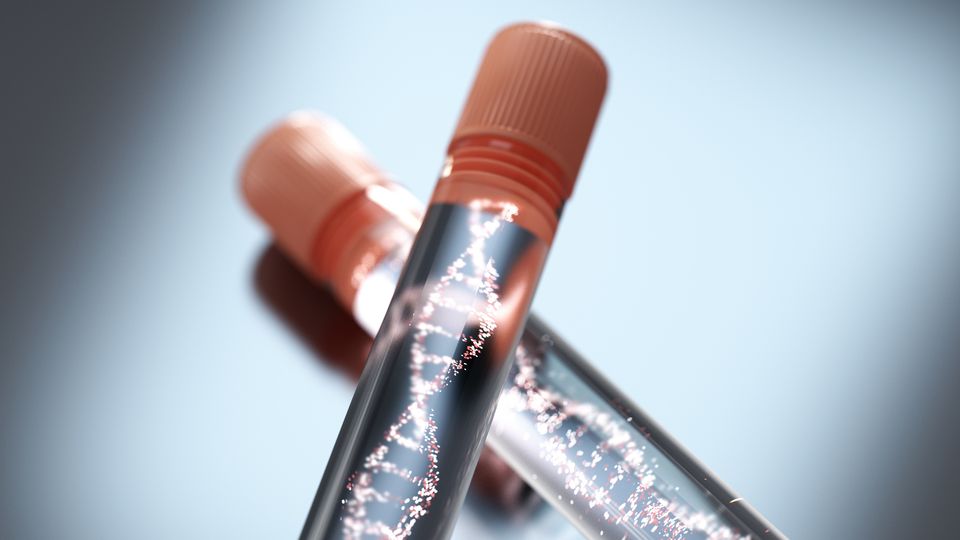 Two test tubes with orange caps containing a clear sample and an image of a DNA double helix.