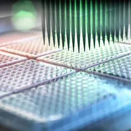 High-throughput screening automated liquid handler above rows of multi-well plates.