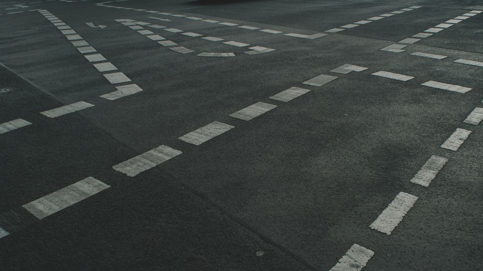Road markings on an asphalt street.