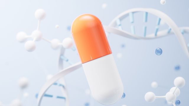 A drug capsule with strands of DNA and molecules in the background. 