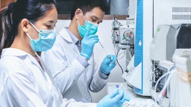 Researchers prepare protein samples at a high‑res mass analysis system, showing rapid protein characterization with MyMassMP. 