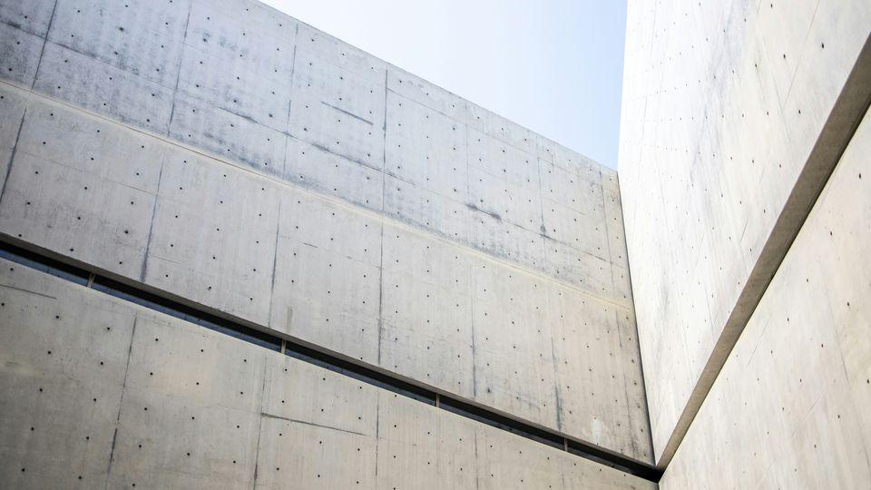The corner where two large cement walls meet.
