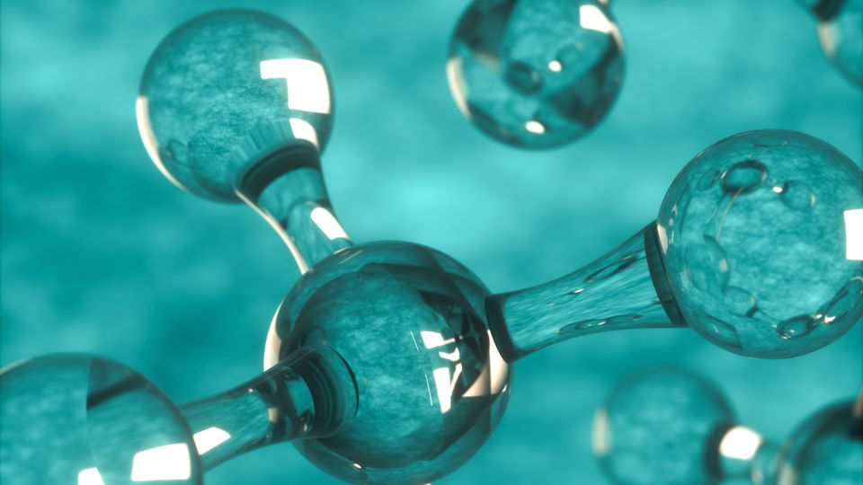 Illustration of a ball and stick molecular model. The model is clear and is on a green background. 