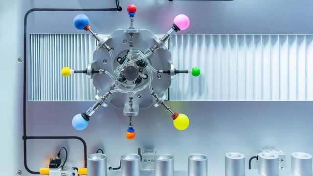 Re Engineer Gas Chromatography system with multi-port valve assembly and color-coded flow controls in laboratory instrumentation. 