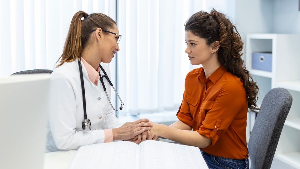 Doctor consulting with a patient in a medical office.