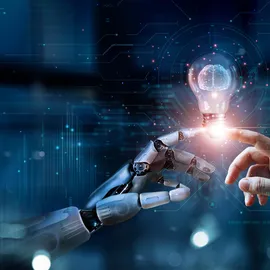 Robot and human hand touching with lightbulb.