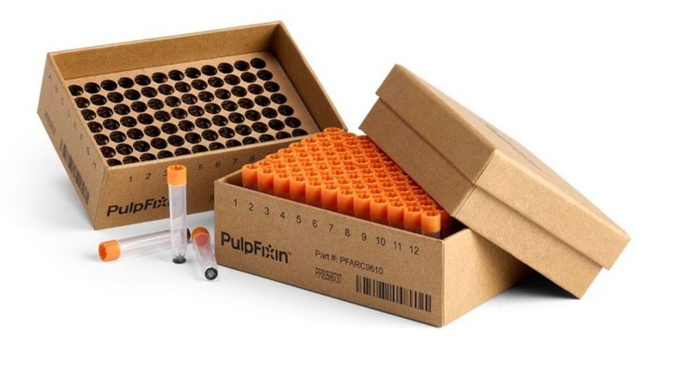 Cardboard grid boxes filled with laboratory sample tubes.