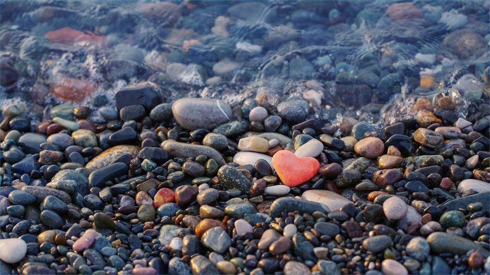 A close up of rocks along a pebble beach, a potential source of marine natural products.