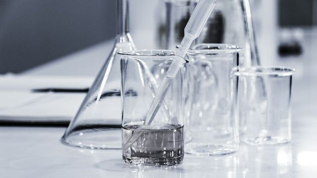Laboratory beakers and pipette on a lab bench. 