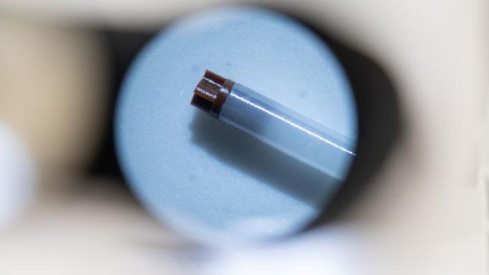 Spinning rotor component viewed through an optical instrument during precision engineering.