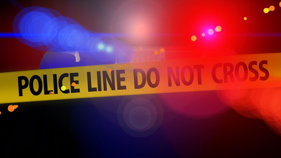 Police line tape reading “Do Not Cross” with flashing red and blue lights, symbolising a forensics crime scene.