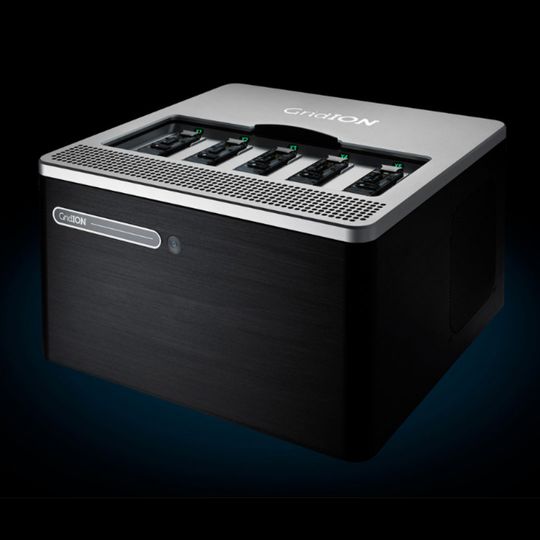GridION benchtop sequencing device with five flow cell slots, shown in black and silver against a dark background. 