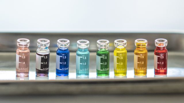 Colorful laboratory vials symbolize Pride in STEMM, celebrating diversity and inclusion in science. 