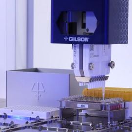 Automated Gilson liquid handling system pipetting samples into a 96-well plate in a laboratory. 