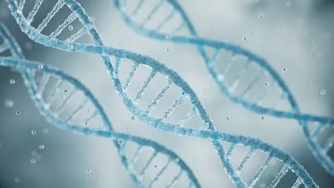 Close-up illustration of blue DNA double helices floating in a soft-focus, light blue scientific background.