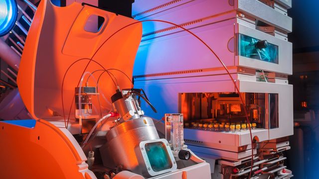 Colourful LC‑mass spec instrument setup with tubing, detectors, and illuminated compartments. 
