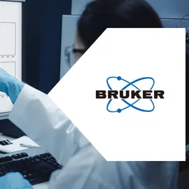 Scientist reviewing mass spectrometry data for POPs & PFAS analysis on a laboratory monitor.
