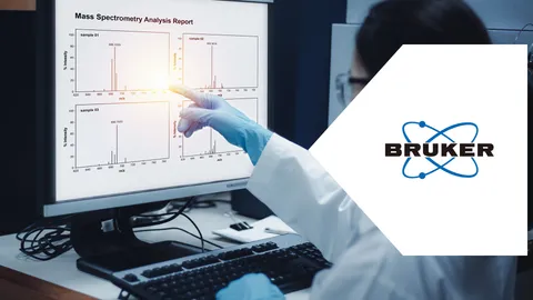Scientist reviewing mass spectrometry data for POPs & PFAS analysis on a laboratory monitor.