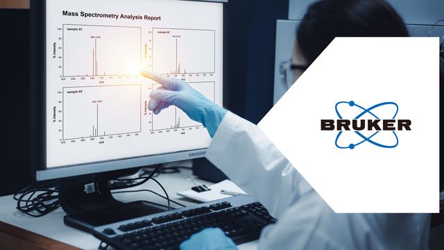 Scientist reviewing mass spectrometry data for POPs & PFAS analysis on a laboratory monitor. 