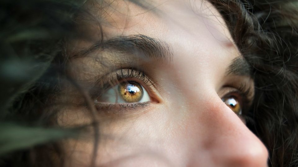 Close-up of brown eyes with long eyelashes and natural light.