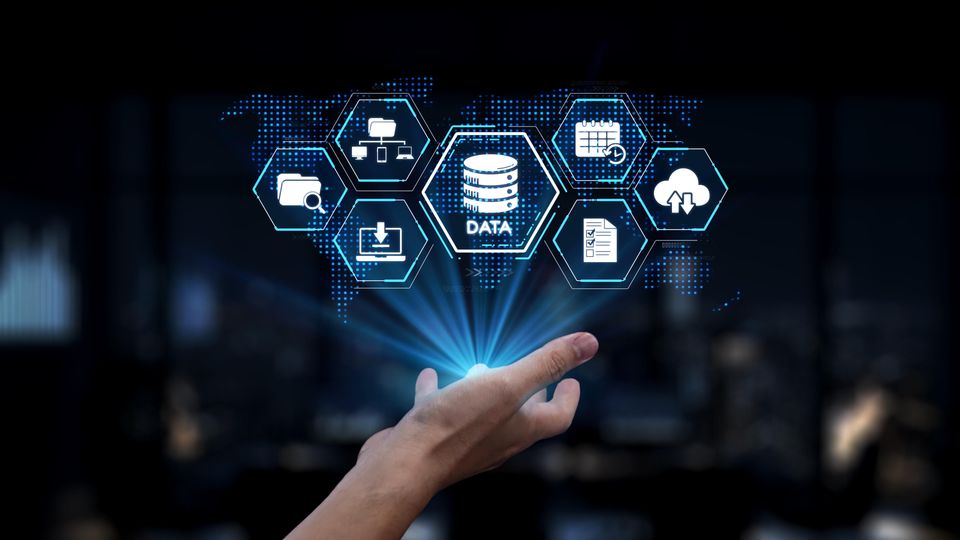 Outstretched human hand holding an illuminated illustration of data management icons.
