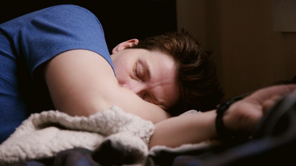 Man sleeping peacefully in bed.
