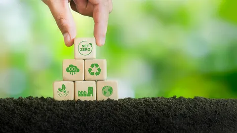 Sustainable GC and GC/MS performance illustrated with hand stacking net zero and recycling blocks on soil.