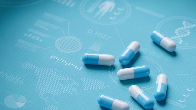 Blue and white capsules on a scientific medical background 