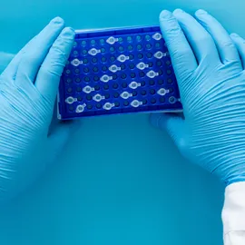 Laboratory technician handling LC sample vials to improve liquid chromatography workflow efficiency and performance.