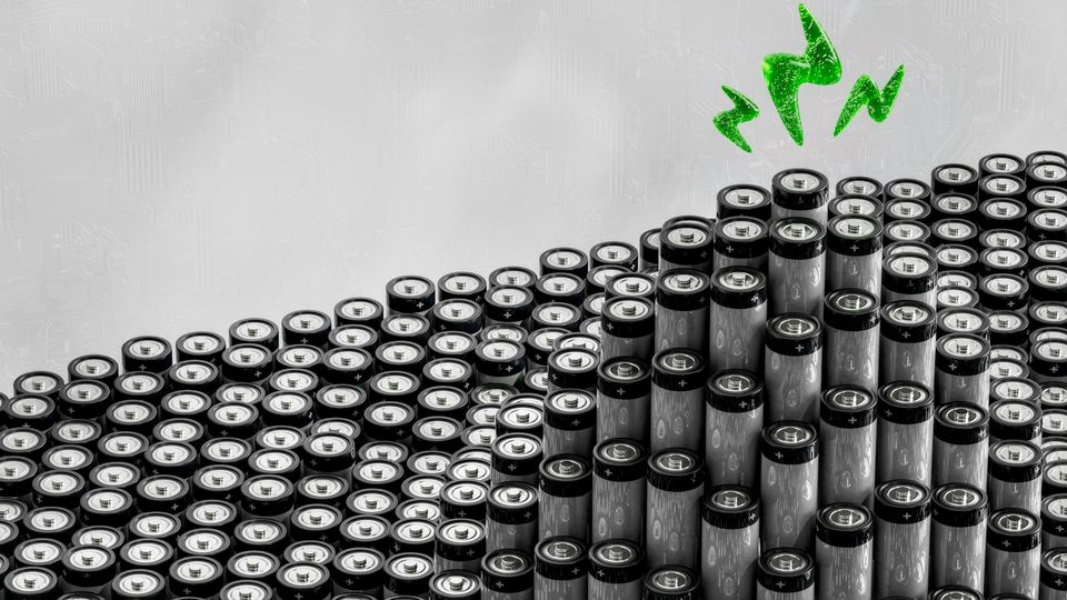 Rows of cylindrical batteries with a green energy waveform above.
