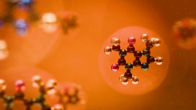 Molecular structures floating around in bubbles against an orange background. 