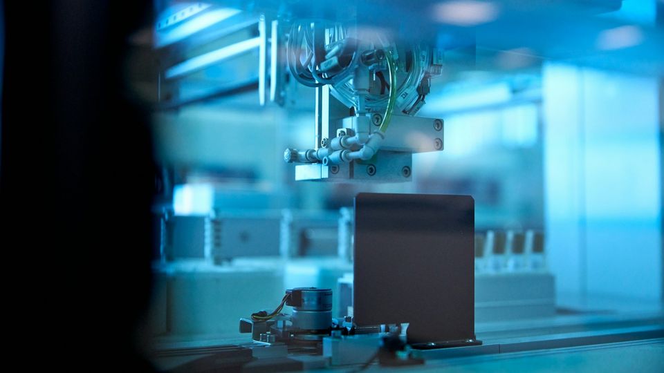 Automated laboratory analyzer processing samples with robotic components in a clinical diagnostics laboratory.