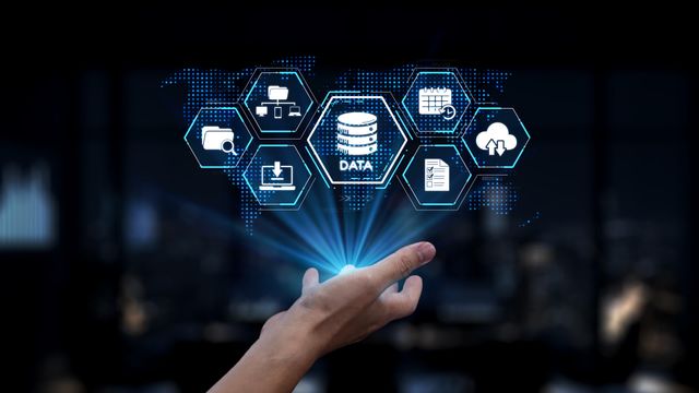 A hand below hexagonal icons relating to data management. 