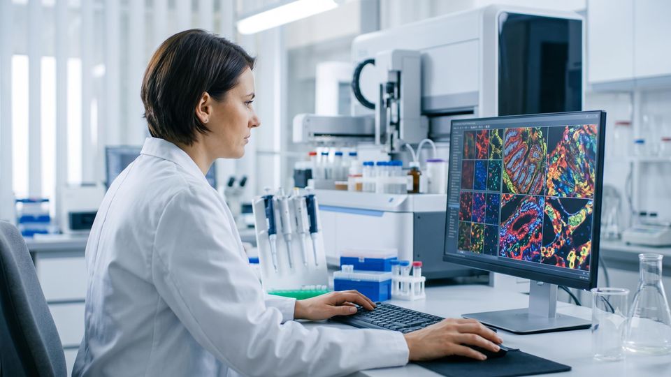 AI-generated image of a researcher reviewing spatial transcriptomics data in a laboratory setting.