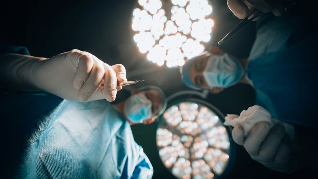 Point-of-view of a patient looking up at surgeons before being given anesthesia for an operation. 