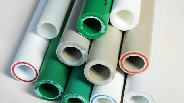 Close-up of PVC plastic pipes used in plumbing, water distribution, and construction systems. 