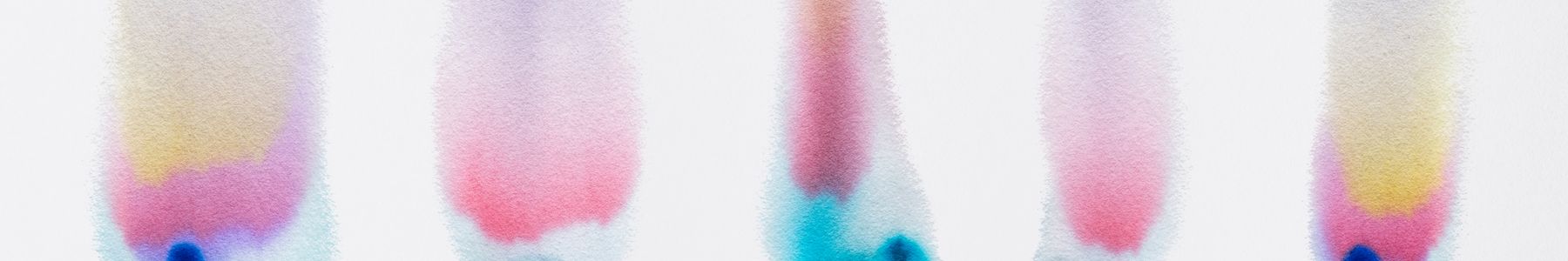 Chromatography columns showing separated colored bands, illustrating analytical separation. 