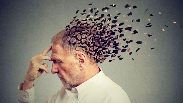 Man experiencing memory loss, with his brain visually depicted as breaking apart. 
