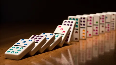 Dominoes falling illustrate the data noncompliance domino effect.