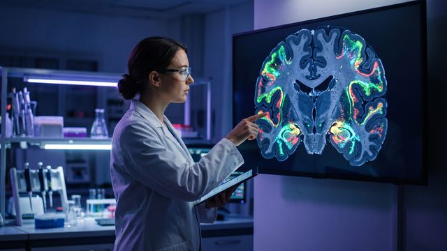 AI-generated image of a researcher examining spatial gene expression maps on a brain section in a neuroscience laboratory. 