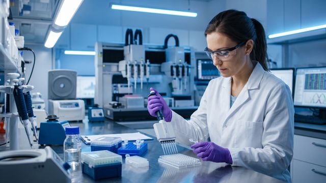 AI-generated image of a scientist pipetting nucleic acid samples in a genomics laboratory for NGS sample preparation. 