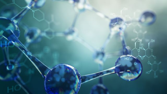 A complicated chemical structure, rendered in 3D with a glass-like effect. 